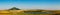 Fields with blooming sunflower. Farm mowing, hay and straw for livestock in winter. Panorama