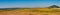 Fields with blooming sunflower. Farm mowing, hay and straw for livestock in winter. Panorama