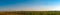 Fields with blooming sunflower. Farm mowing, hay and straw for livestock in winter. Panorama