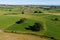 Fields, farm plots in the south of Ireland, top view. Irish agrarian landscape. Green fields on a sunny summer day. Green grass