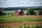 Fields with a red barn in the summertime countryside, countryside setting farm construction farm upbringing. Generative AI