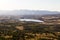 Fields and a small lake framed by mountains. green and yellow colors. panoramic photo. Wonderful view. drone