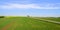 Fields and vineyard with road and wind turbines