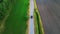 Fieldway drive: aerial view of car gliding through verdant landscape