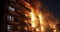 A Fierce Blaze Engulfs an Apartment at Night, Clouding the Air in Smoke