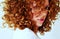 Fierce mixed young woman with curly red hair