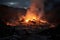 Fiery blaze emerges from massive mound of earth and debris