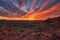 fiery canyon sunset, with view of distant city skyline, and clouds in the sky