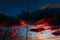 Fiery contrasting clouds in the blue sky, at sunset, through the masts of sailing yachts.