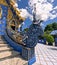 Fiery dragon wood carving railing of Wat Rong Suea Ten Blue Temple at Chiang Rai Thailand