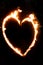 a fiery heart glows with a red flame at night. valentine's day and love symbol