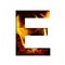 Fiery letter E from white paper on a background of fire in a fireplace or stove, decorative alphabet