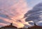 Fiery orange, pink stormy sky and alarming storm clouds at dawn