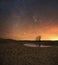 Fiery sky and dry lake on a cold night.