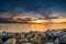 Fiery Sunset behind rocky shore