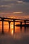 Fiery sunset on Kanonersky Island in St. Petersburg. Western high-speed diameter. Automobile bridge. The Gulf of Finland. Orange