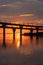 Fiery sunset on Kanonersky Island in St. Petersburg. Western high-speed diameter. Automobile bridge. The Gulf of Finland. Orange