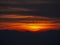 Fiery sunset from mountain peak in a cloudy evening. Fall season. Orobie mountains. Italian Alps