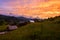 Fiery sunset over the alpine village, nature landscape