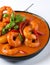 Fiery Temptation: Close-Up of Spicy Shrimp Curry on a White Background. AI Generated