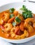 Fiery Temptation: Close-Up of Spicy Shrimp Curry on a White Background. AI Generated