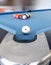 Fifteen billiard spheres lay on blue clot