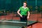 Fifteen year old teen girl plays ball in table tennis