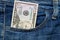 Fifty American dollars bill in pocket of blue jeans