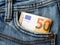 Fifty euro banknote in a blue jeans pocket. Wealth, cash savings, accounting of income and expenses concept