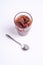 Fig jam in glass with spoon, breakfast mood fruit food on white background