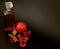 Fig-pomegranate liqueur with cinnamon and anise on a black background, strong homemade alcohol in a crystal decanter and two