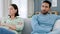 Fight, divorce and angry couple on a sofa in living room at home with husband hurt after erectile dysfunction argument