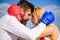 Fight for your happiness. Man and girl cuddle happy after fight. Couple in love boxing gloves hug sky background