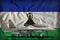 Fighter, interceptor on the Lesotho state flag background. 3d Illustration