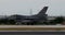 Fighter jet aircraft lands. Side view with panning. Blurred background