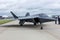 A fighter jet is stationed on top of an airport tarmac, ready for action, Unveiling of a new stealth fighter aircraft at an