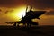 Fighter plane at sunset on carrier ship