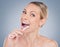 Fighting the good fight against cavities. Studio portrait of an attractive young woman brushing her teeth against a grey