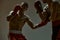 Fighting guys boxers during workout on gray studio background. Athletic males in boxing gloves training