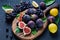 Figs, black grapes and lemons. Fresh fruits plate