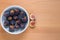 Figs fruits in a bowl on wooden background, top view