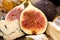 Figs, half of figs, brie and blue cheese on old wooden background. Dieting healthy eating concept. Close up.