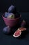 Figs in a plate on a black background