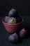 Figs in a plate on a black background