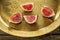 Figs on vintage copper dish with traditional oriental ornament close up.