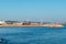 Figueira da Foz PORTUGAL - 13 August 2021 - Breakwater with a small sandy beach in with silhouettes of holidaymakers and a bridge