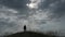figure of active male standing on windy hill meditation on cloudy sky background during outdoor leisure activity