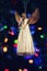 Figure of an angel decorating on Christmas tree with nice colorful boke background