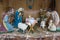 Figure of Birth of Jesus in farm shed.Christmas nativity scene with three Wise Men presenting gifts to baby Jesus