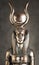 The figure of the Egyptian goddess Isis on a brown corduroy background. Bronze statuette